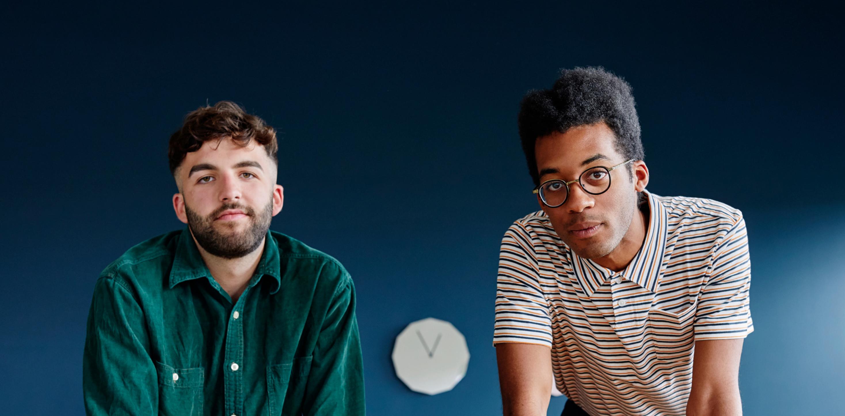 Two people standing at a desk